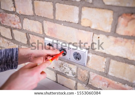 Detail of an electrician during the installation work.