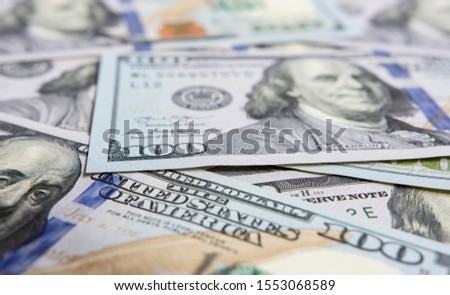 Closeup on hundred dollars bills Royalty-Free Stock Photo #1553068589