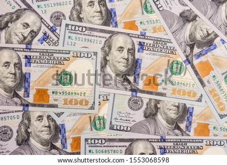 Several hundred dollars bills spread Royalty-Free Stock Photo #1553068598
