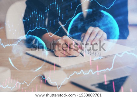 Forex graph on hand taking notes background. Concept of research. Multi exposure
