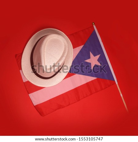 Puerto Rico flag with a traditional hat isolated on a red background.