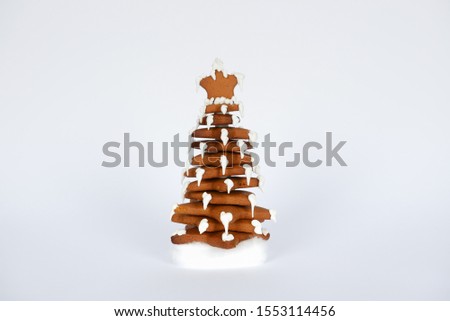 The hand-made eatable gingerbread New Year tree in snow decoration