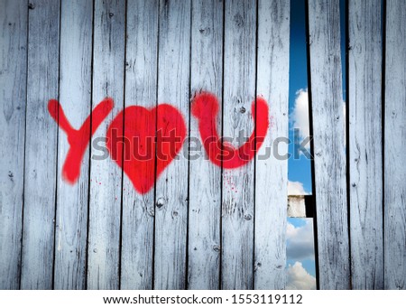 Declaration of love graffiti on a wooden fence