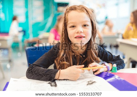education and school concept little student girl studying at school