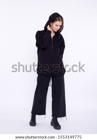 Young girl wearing blank and oversize black long hoody. White background