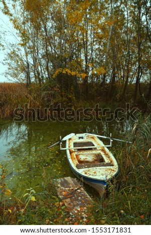 Wooden  rowing fishing boat  at banks of the lake