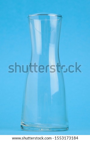 empty glass flower vases on blue background