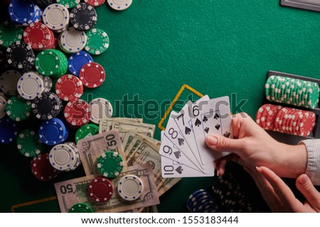 casino background, street flash cards for the player and dollars and chips on the poker table. Gaming business, success. With space for design. Online casino, online poker.