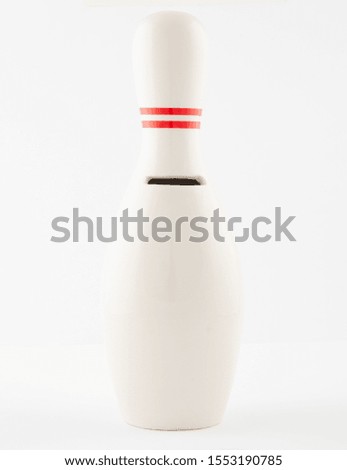 White ceramic piggy bank shaped as a bowling pin. Isolated on white background.