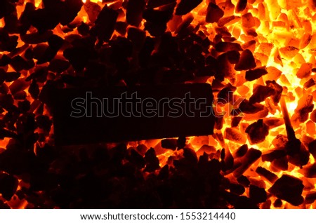 
A piece of iron lies on a burning corner.