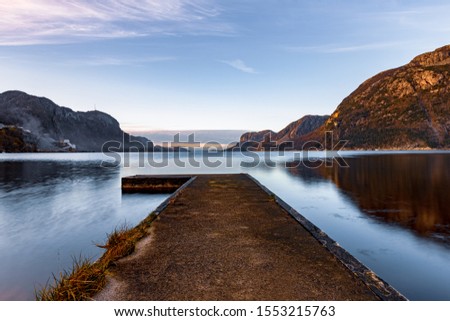 Small pier in a Norwegian fjord in the evening hours