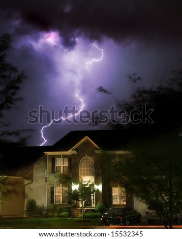 Dramatic lightening storm over suburban home Royalty-Free Stock Photo #15532345