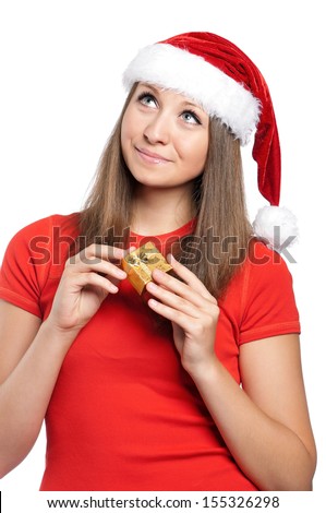 Beautiful teen girl in Santa hat with gift box posing on white background