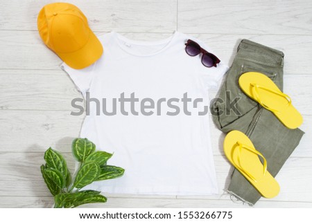 T-shirt top view, t shirt mock up, empty tshirt. Summer concept casual clothes background copy space. Blank shirt on wooden background