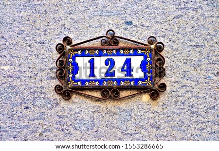 Number 124, one hundred and four, beautiful tiles in steel floral frame.