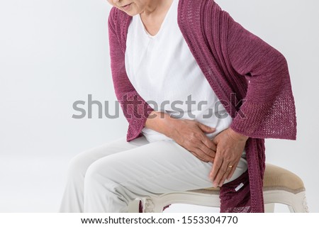 The old woman who has a pain in a hip joint Royalty-Free Stock Photo #1553304770