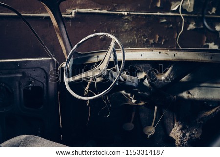 The inside of an old abandoned manual gearbox car with protruding wires