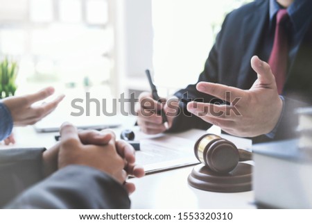 Justice lawyer meeting with contract papers and Judge gavel on tabel in courtroom. Attorney working in courtroom. Justice and law, attorney, court judge concept.

