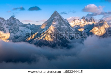Early morning light on the summit of Gongga mountain peak which look like paramount picture mountain 