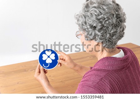 Old woman with a person with a Japanese disability mark