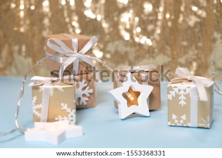 Christmas gift on Blackground of abstract glitter lights. Gold and white. Blurred