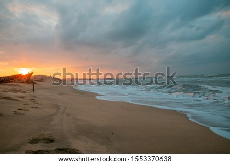 
sunset at sea during a storm on the shore of a fishing boat