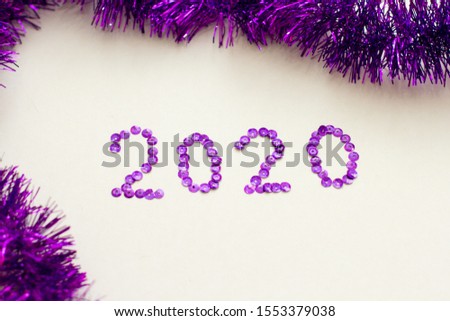 Inscription 2020 year of sparkles. Christmas decororation on a white background.
