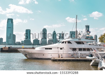 New Jersey skyline from Battery Park in a sunny day. Luxury yacht in the foreground. City, travel and luxury concept. Manhattan, New York City, USA.