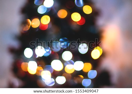 Abstract blurred background of blue and silver glittering shine bulbs lights garland. Christmas wallpaper decorations concept. Xmas holiday background