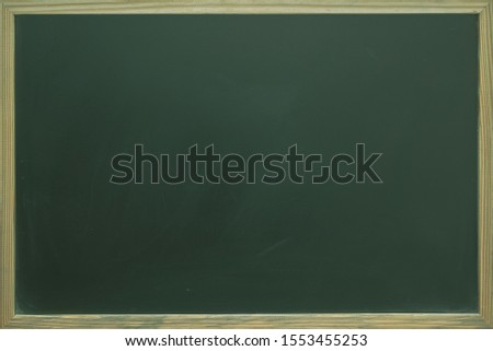 Abstract texture of chalk rubbed out on blackboard or chalkboard with wooden frame, can be use for advertisement, background, education, banner or website concept.