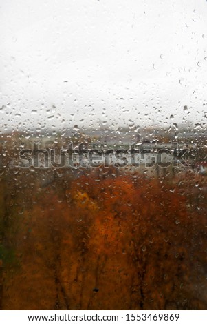 Drops on a window pane after rain in autumn sad picture background   