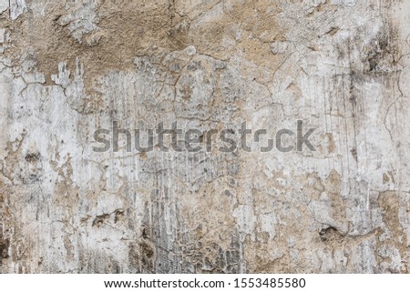 Destroyed chipped wall of cellar farm house. Dirty exterior urban facade. Whitewashed ruined structure background. Grunge uneven old stone rock texture. Outside crack crash cement mortar for 3d design