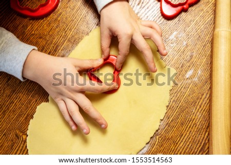 Gift ideas for Mothers or Valentine’s day. Inspired and interested boy preparing heart shape cookies. Food made with love. Do what you love. Concept - time with kids.