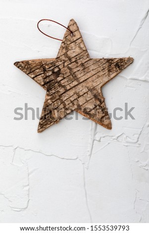Beautiful star of birch bark on white textured background. Ready for Christmas greeting.