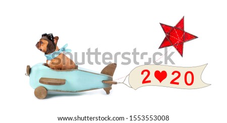 merry christmas - french bulldog in wooden aircraft with christmas star and 2020 banner
