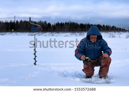 Winter season fisherman goes fishing