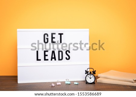 Get leads. Business concept. White lightbox on a wooden table