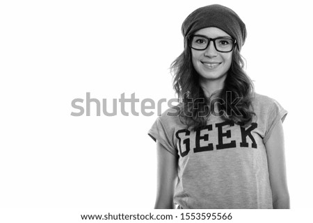 Studio shot of happy geek girl smiling while wearing eyeglasses