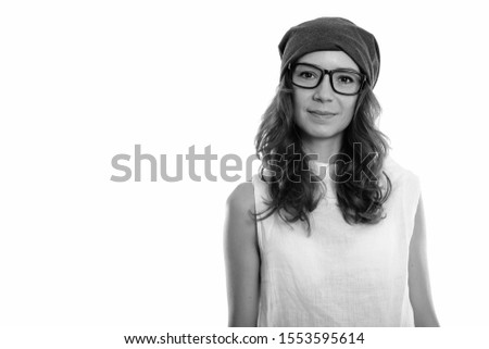 Studio shot of young beautiful woman wearing eyeglasses