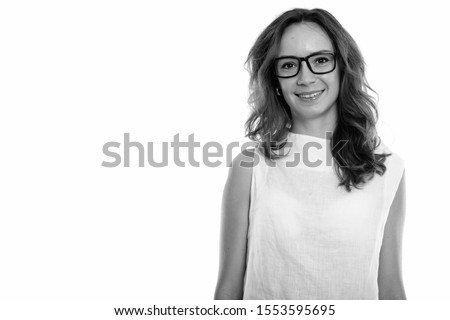 Studio shot of happy young beautiful woman smiling while wearing eyeglasses