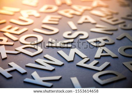 Mixed solid letters pile closeup photo. Education background concept