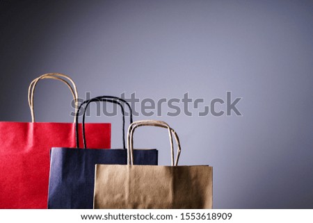 Black friday, craft black, red, brown packets, on a gray background with place for text