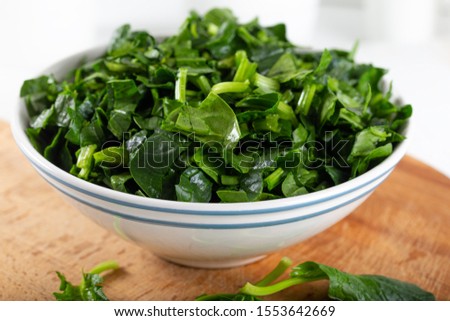 Chopped fresh spinach in a bowl Royalty-Free Stock Photo #1553642669