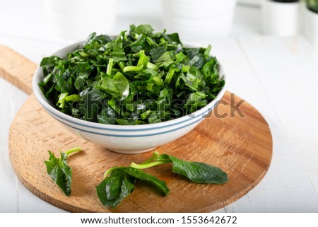 Chopped fresh spinach in a bowl Royalty-Free Stock Photo #1553642672