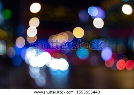 Photo of a bokeh-style night city with lanterns, headlights and city lights
