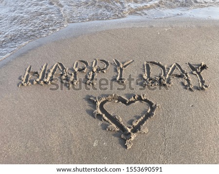 Happy Day character and heart on beach.