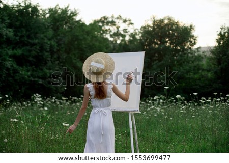 woman young artist outdoors easel with paints