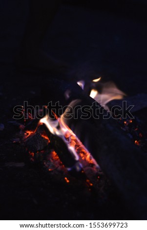 Enjoy the atmosphere of a blue campfire in the camping area on the mountain