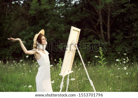 young woman in a beautiful white dress in a clearing