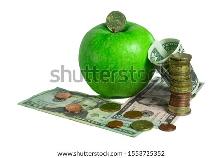 Green apple with coins and dollar bills